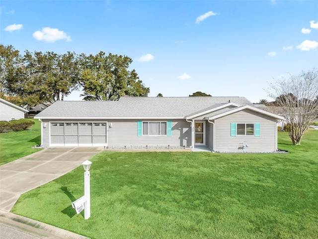 ranch-style house featuring a garage and a front yard