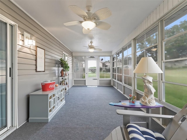 sunroom featuring ceiling fan