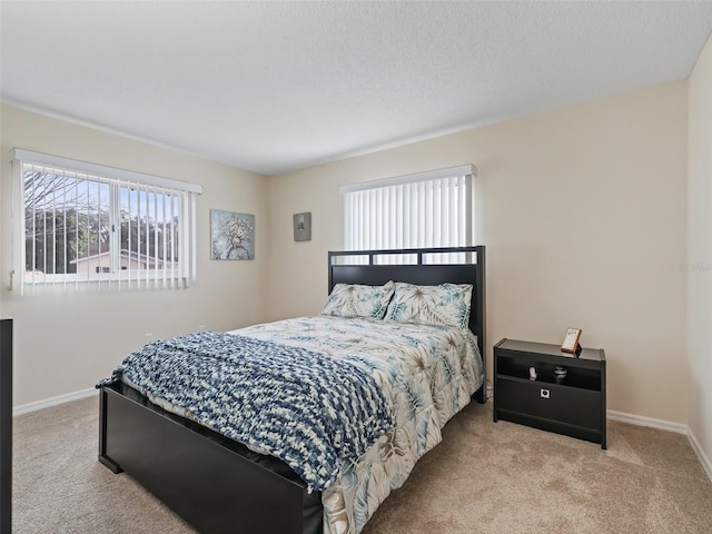 bedroom with light carpet and a textured ceiling