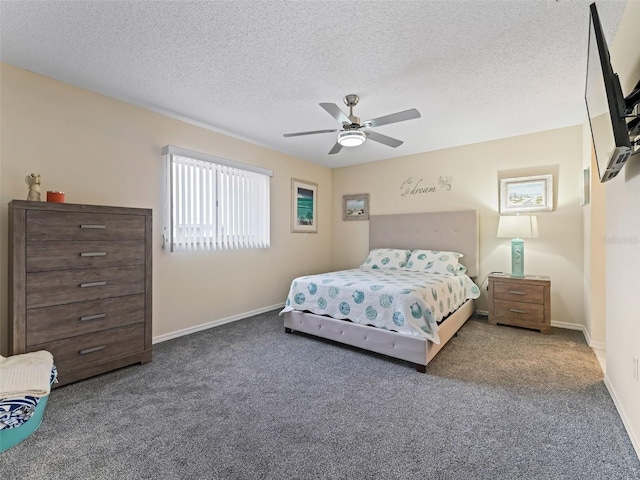 bedroom with ceiling fan, a textured ceiling, and dark carpet