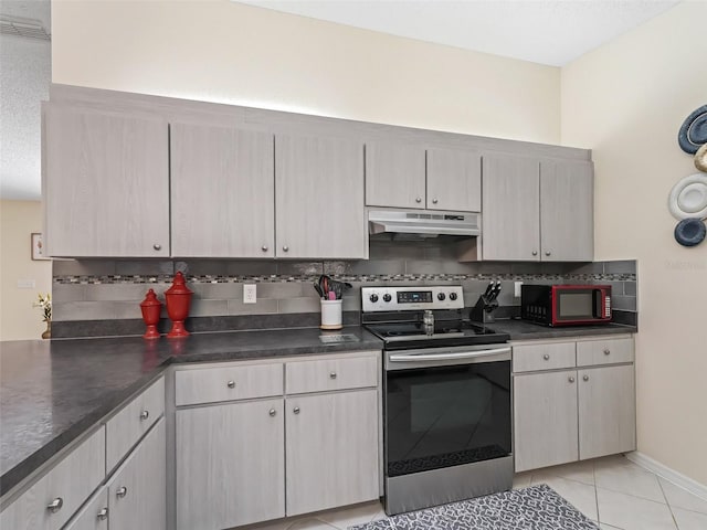 kitchen featuring electric stove, tasteful backsplash, and light tile patterned flooring