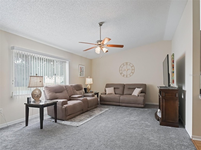 carpeted living room featuring lofted ceiling, a textured ceiling, and ceiling fan