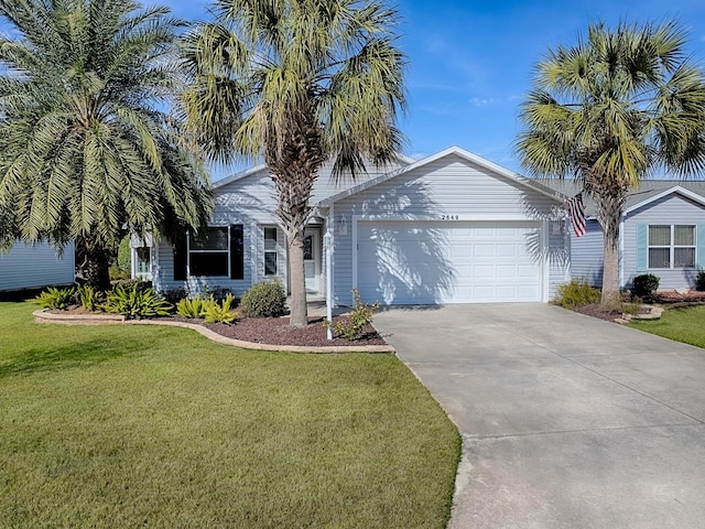 view of front of home with a garage and a front lawn