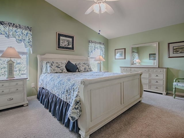 carpeted bedroom featuring lofted ceiling and ceiling fan