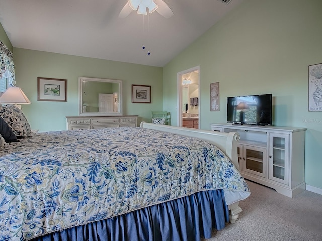 bedroom featuring light carpet, vaulted ceiling, ceiling fan, and ensuite bathroom