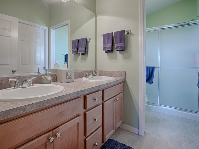 bathroom with walk in shower, vanity, and toilet