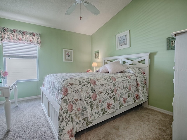 carpeted bedroom featuring ceiling fan, lofted ceiling, and a textured ceiling