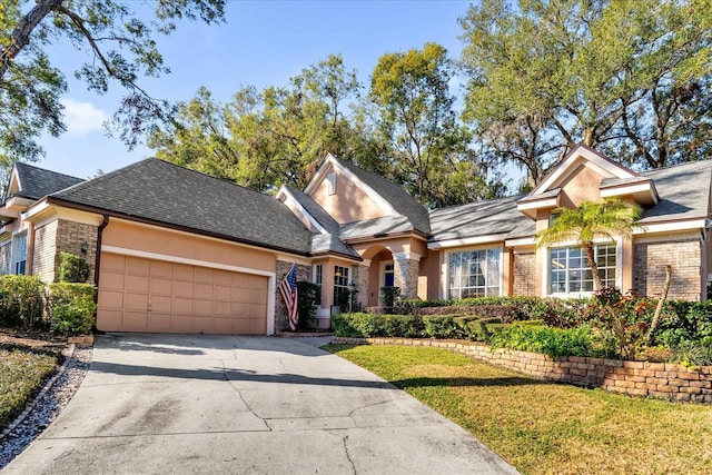 view of front of house with a garage and a front lawn