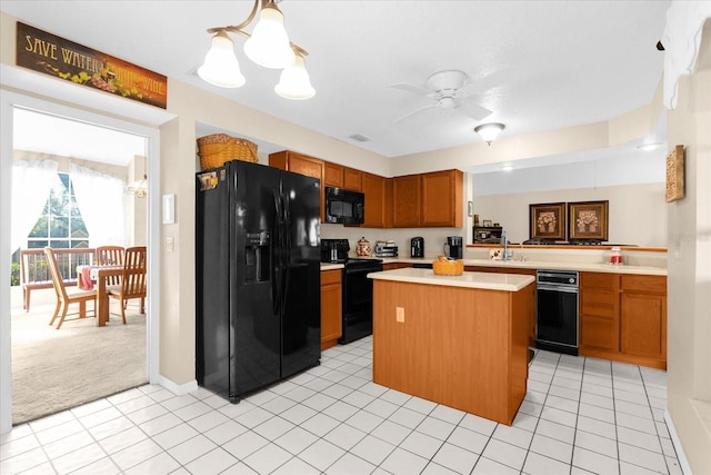 kitchen with black appliances, a kitchen island, light carpet, decorative light fixtures, and kitchen peninsula