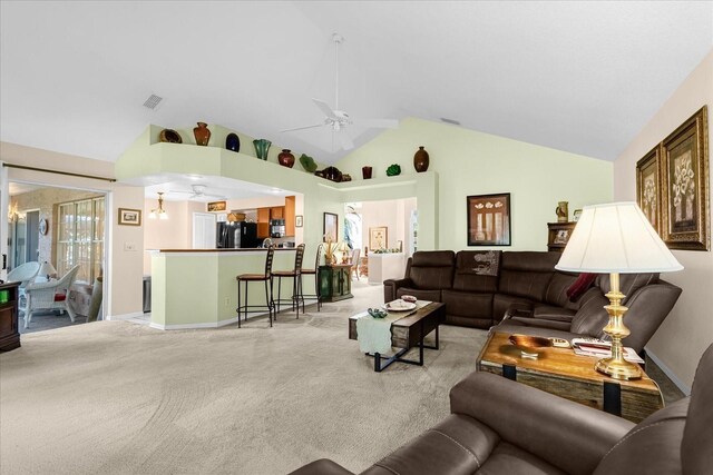 carpeted living room with high vaulted ceiling and ceiling fan