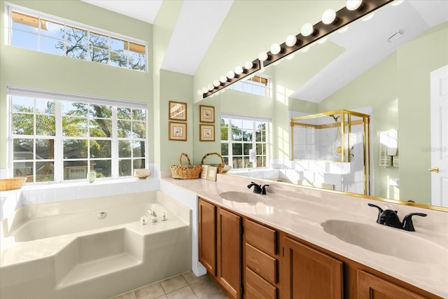 bathroom with shower with separate bathtub, vaulted ceiling, tile patterned floors, and vanity