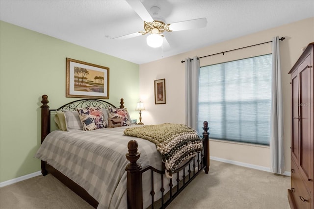 bedroom featuring light carpet and ceiling fan