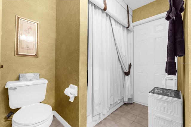 bathroom featuring tile patterned floors and toilet