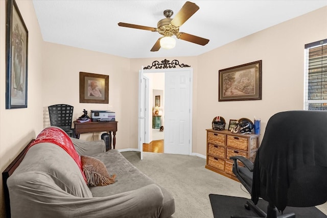 carpeted home office with ceiling fan