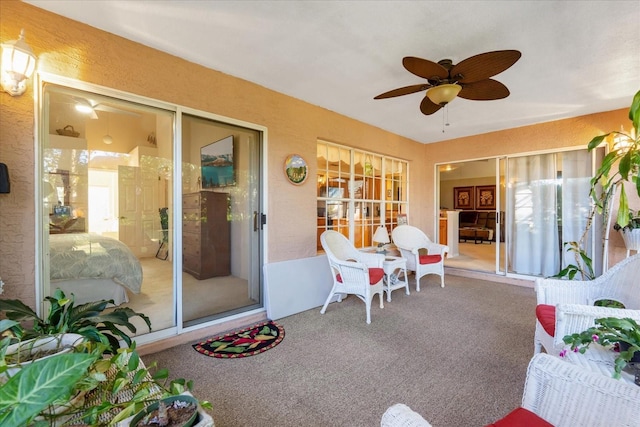 interior space with ceiling fan