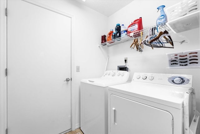 washroom with independent washer and dryer