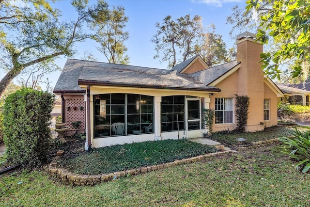 back of house with a lawn