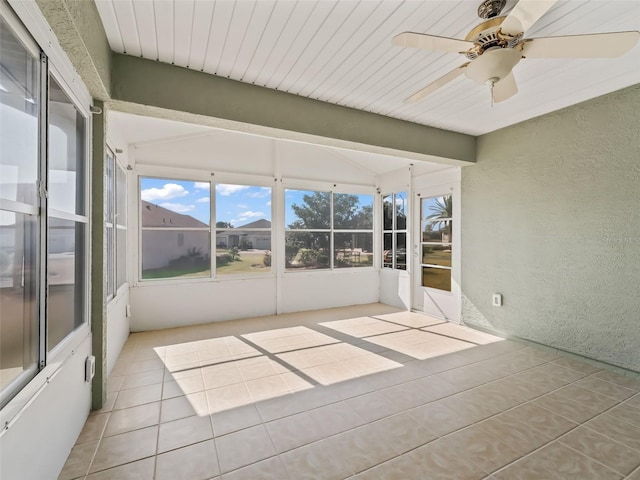 unfurnished sunroom with vaulted ceiling with beams, wood ceiling, and ceiling fan