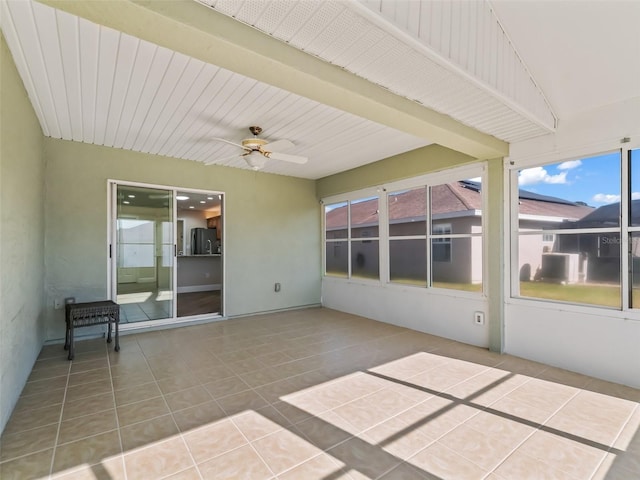 unfurnished sunroom with beam ceiling and ceiling fan