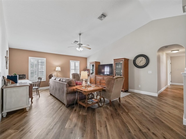 living room featuring lofted ceiling, dark wood-type flooring, and ceiling fan