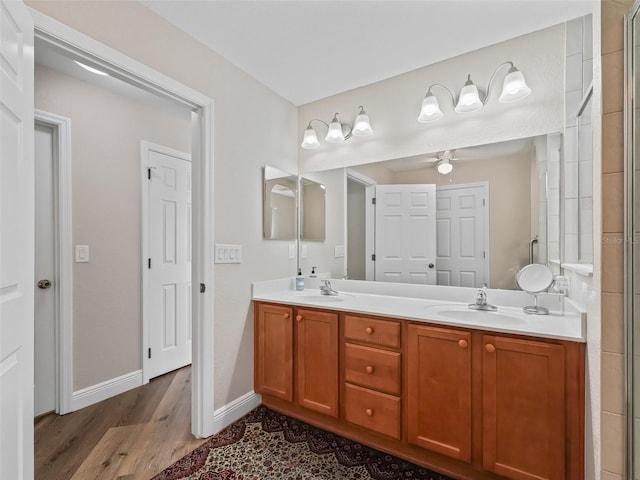 bathroom with vanity, hardwood / wood-style floors, a shower with door, and ceiling fan