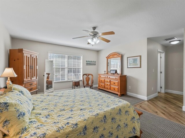 bedroom featuring hardwood / wood-style flooring and ceiling fan