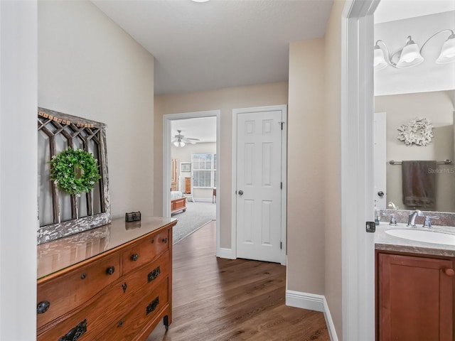 hallway with sink and dark wood-type flooring