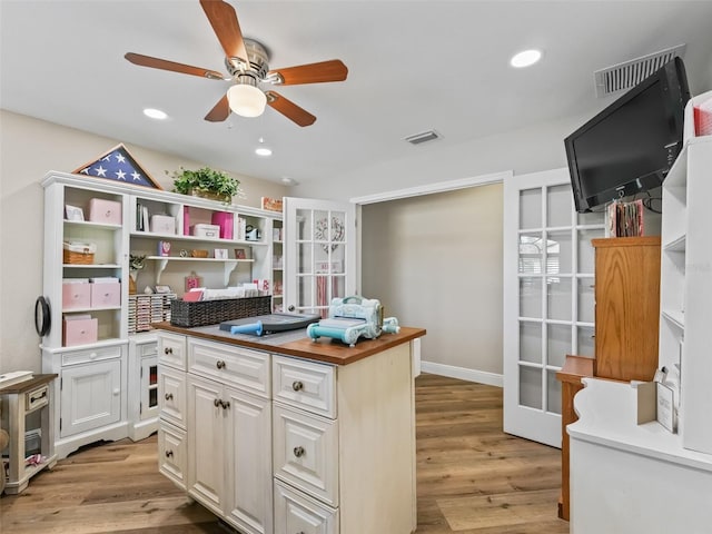 office featuring ceiling fan and light hardwood / wood-style flooring