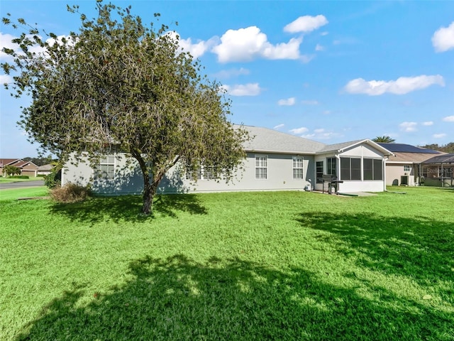 rear view of property with a yard