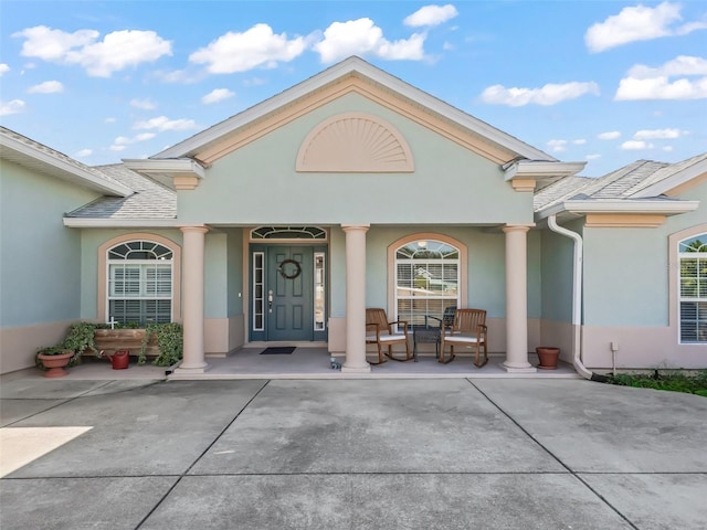 view of exterior entry with a porch