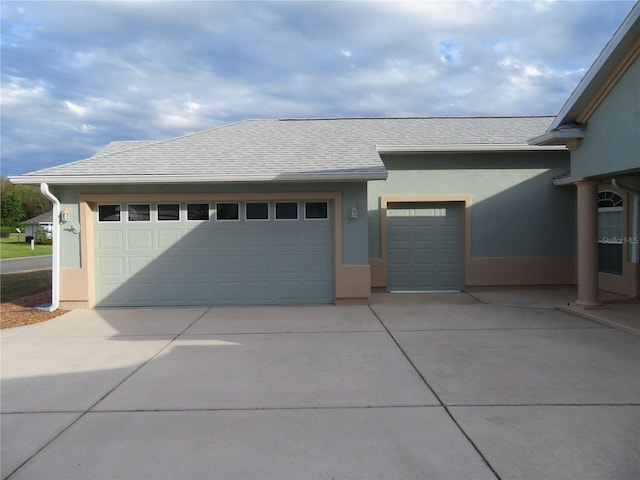 garage featuring concrete driveway