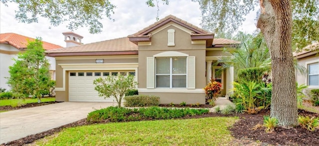 mediterranean / spanish-style home featuring a garage and a front lawn