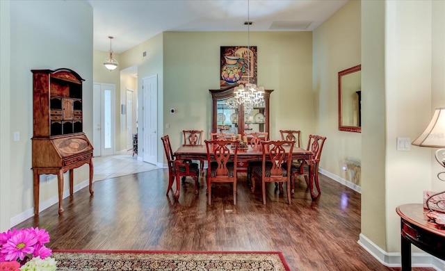 dining room featuring dark hardwood / wood-style floors and a high ceiling