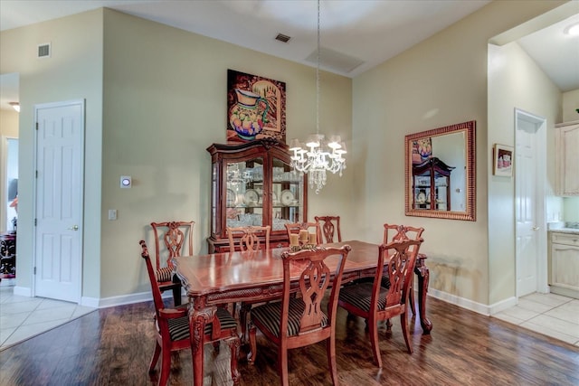 dining room with an inviting chandelier and light hardwood / wood-style floors