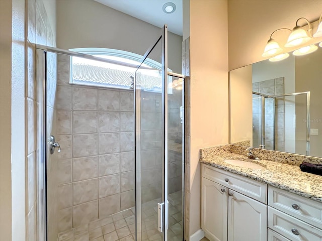 bathroom featuring vanity and a shower with shower door