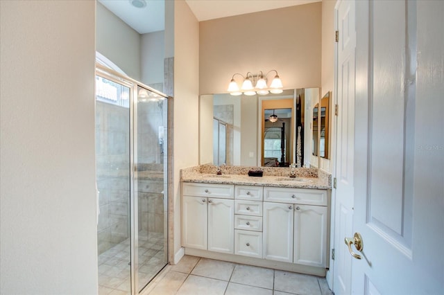 bathroom featuring tile patterned flooring, vanity, and walk in shower