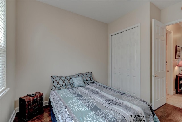 bedroom featuring dark hardwood / wood-style flooring and a closet