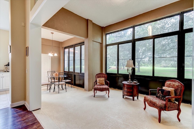 sitting room featuring hardwood / wood-style floors and a chandelier