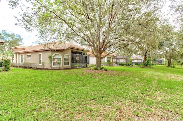 view of yard with a sunroom