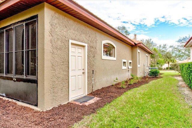 view of side of home with a yard