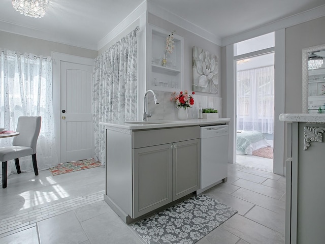 kitchen with ornamental molding, gray cabinets, dishwasher, and sink