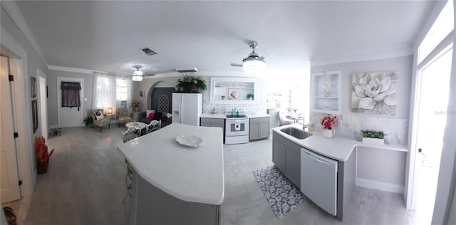 kitchen with sink, gray cabinetry, ornamental molding, built in features, and white appliances