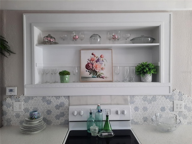details featuring electric stove and decorative backsplash