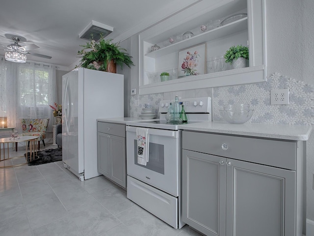 kitchen with gray cabinets, ceiling fan, backsplash, and white appliances