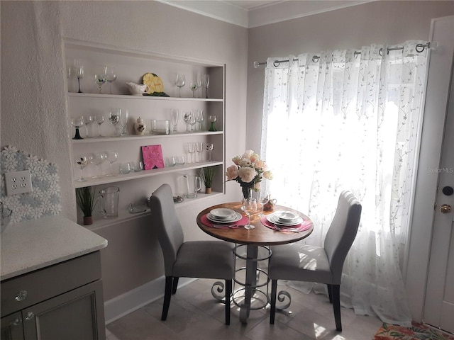 tiled dining room featuring built in features