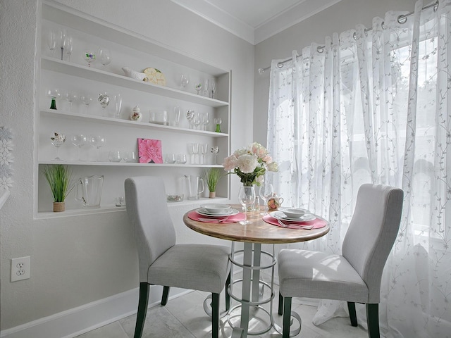 dining area featuring built in shelves, plenty of natural light, ornamental molding, and light tile patterned flooring