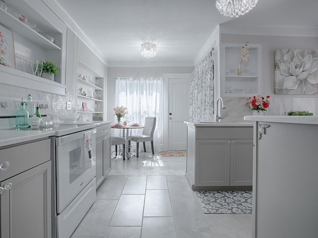 kitchen with built in shelves, sink, crown molding, gray cabinets, and electric stove