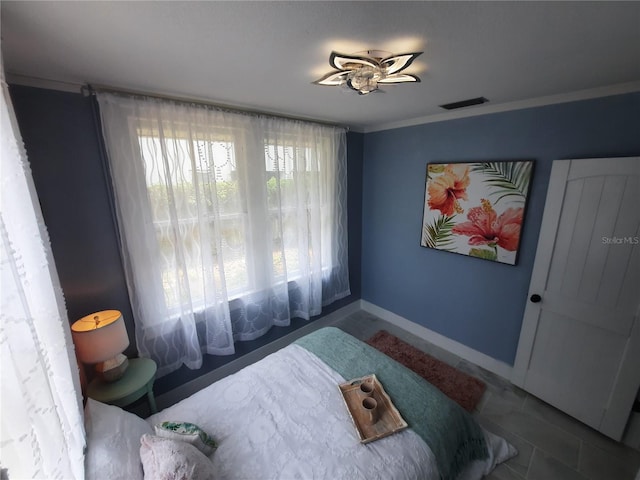 bedroom featuring ornamental molding and tile patterned floors