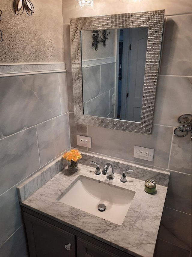 bathroom with tile walls and vanity