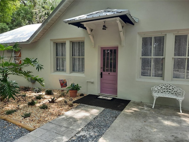 doorway to property featuring a patio